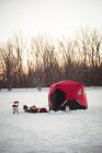 Rotes Fischerzelt in verschneiter Landschaft und Bäumen — Stockfoto