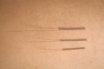 Close-up of three needles for dry needling on skin — Stock Photo