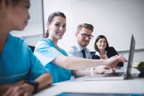 Doctors discussing over laptop in meeting at conference room — Stock Photo