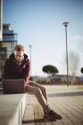 Männliche Führungskraft benutzt Laptop im Hof eines Bürogebäudes — Stockfoto
