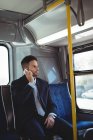 Businessman talking on the mobile phone while travelling in bus — Stock Photo