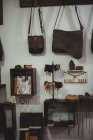 Various leather accessories hanging in workshop — Stock Photo
