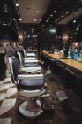 Barber chairs arranged in a row at barber shop — Stock Photo