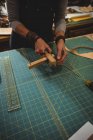 Sección media de la artesana que prepara el cinturón de cuero - foto de stock