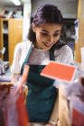 Female staff working at food counter in supermarket — Stock Photo