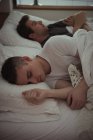 Gay couple sleeping together on the bed in bedroom — Stock Photo