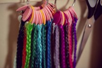 Close-up of artificial dreadlocks materials hanging in shop — Stock Photo