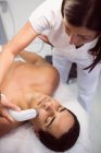 Patient receiving facial treatment at clinic — Stock Photo