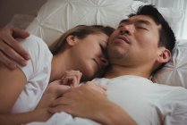 Couple sleeping together in bedroom at home — Stock Photo