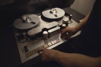 Audio engineer using track recorder in recording studio — Stock Photo