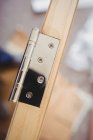 Close up of hinges on wooden door — Stock Photo