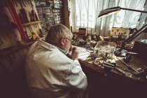 Horologist repairing a watch in the workshop — Stock Photo