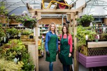 Portrait of female florists standing together at garden centre — Stock Photo