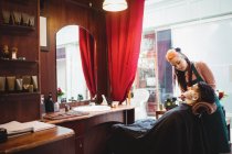 Чоловік голиться з щіткою для гоління в перукарні — стокове фото