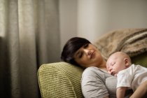 Крупный план матери и ребенка, спящих на диване в гостиной на дому — стоковое фото
