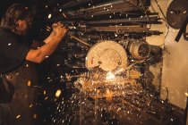 Blacksmith using circular saw machine in workshop — Stock Photo