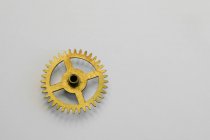 Clock gears on white paper in workshop — Stock Photo