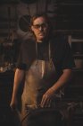 Portrait of blacksmith working at work shop — Stock Photo
