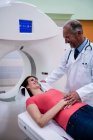 Doctor consoling patient before mri scan at hospital — Stock Photo
