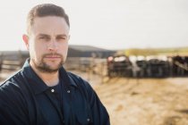 Close-up portrait of confident smart farm worker standing on field — Stock Photo