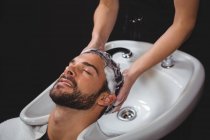 Homem recebendo sua lavagem de cabelo no salão — Fotografia de Stock