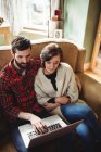 Young couple using laptop in living room at home — Stock Photo