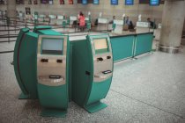 Self service check-in machines in airport terminal — Stock Photo