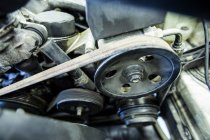 Gros plan du moteur et des composants de la voiture au garage de réparation — Photo de stock