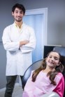 Retrato de dentista y paciente joven en clínica dental - foto de stock