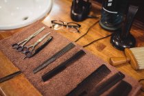 Barber combs, scissors and accessory on wooden table in barber shop — Stock Photo