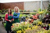 Portrait of female florists smiling in garden centre — Stock Photo