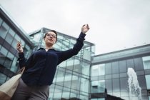 Low angle view of businesswoman gesturing outside office — Stock Photo