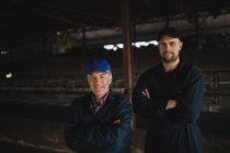 Portrait of confident coworkers standing in barn — Stock Photo