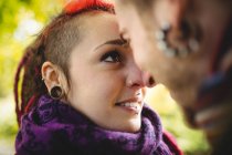 Close-up of smiling young couple in park — Stock Photo