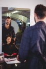 Handsome hair stylist with client at hair salon — Stock Photo