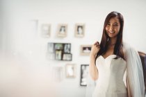 Porträt einer lächelnden Frau beim Anprobieren eines Hochzeitskleides im Geschäft — Stockfoto