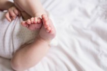 Cropped image of Baby sleeping on bed in bedroom at home — Stock Photo