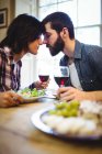 Casal de romances enquanto toma vinho e jantar em casa — Fotografia de Stock