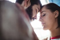 Close-up of young couple embracing each other at home — Stock Photo