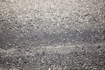Close-up of a tyre track on gravel road — Stock Photo