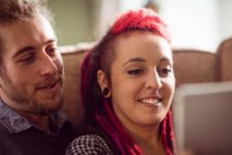 Young hipster couple relaxing on sofa at home — Stock Photo