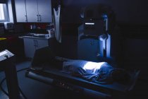Patient couché sous une machine à rayons X à l'hôpital — Photo de stock