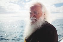 Fisherman looking at sea from boat — Stock Photo