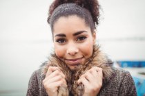Close-up portrait of young woman holding fur — Stock Photo