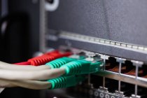 Close-up of ethernet connected in sockets at server room — Stock Photo