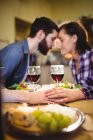 Couple romancing while having wine and dinner at home — Stock Photo