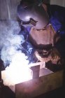 Welder welding metal in workshop — Stock Photo