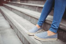 Low section of woman sitting on steps — Stock Photo