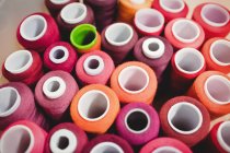 Colorful spools of threads in box in sewing studio — Stock Photo