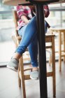 Section basse de la femme assise à la table dans le restaurant — Photo de stock